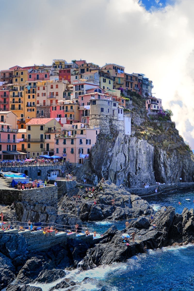 Vibrant houses perched on cliffs overlooking the sea in Manarola, Italy.