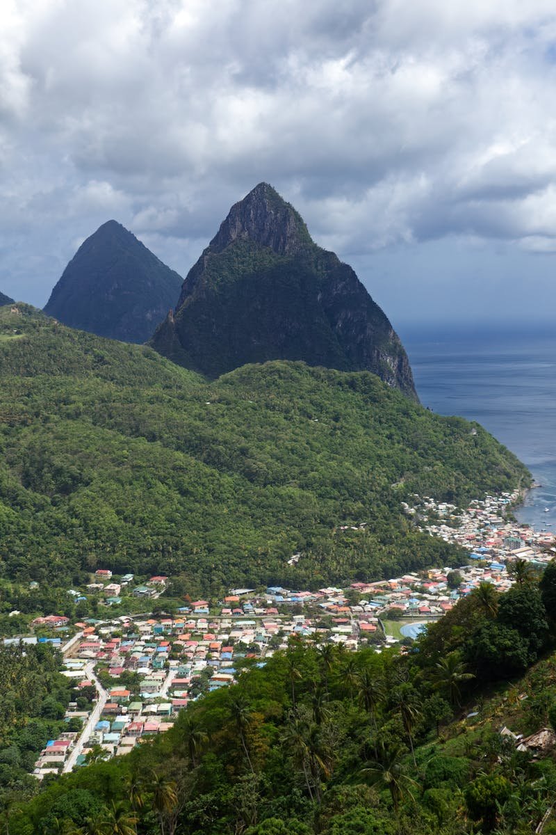 Discover the lush green landscapes and iconic Pitons of Soufriere, Saint Lucia from above.